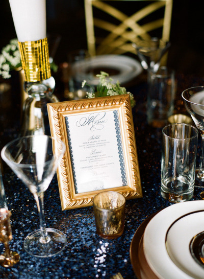 Hand Calligraphy menu card in navy blue framed in gold
