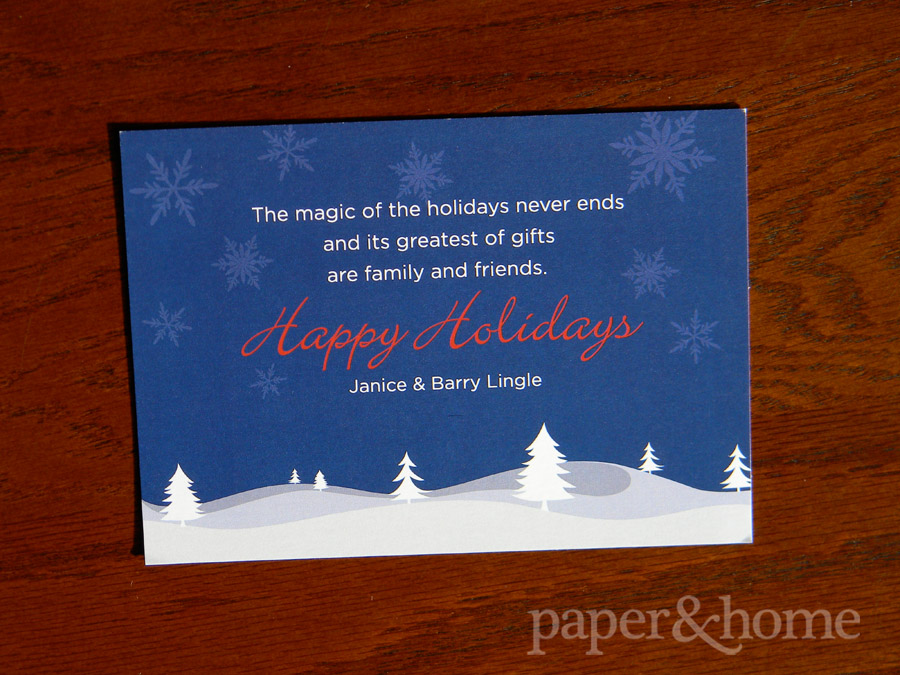 Snowflakes, snowy trees and hills holiday card